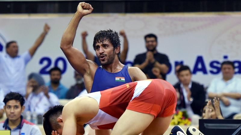 Bajrang Punia first pushed his opponent out of the mat to take one point and then took the Korean down for two more to lead 3-2. (Photo: PTI)