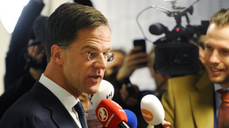 Dutch Prime Minister Mark Rutte answers journalists questions after casting his vote for the Dutch general election in The Hague, Netherlands. (Photo: AP)