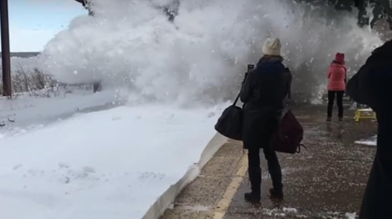 A train entered the station, blasting snow from the tracks onto the platform and the waiting commuters. (Photo: Videograb)