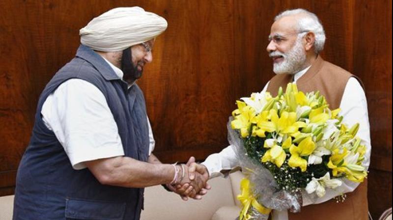 Punjab Chief Minister Amarinder Singh calling on Prime Minister Narendra Modi at Parliament House in New Delhi on Wednesday. (Photo: PTI)
