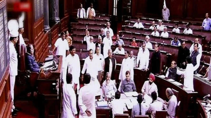 Members protest in the well of Rajya Sabha in New Delhi on Friday. (Photo: PTI)