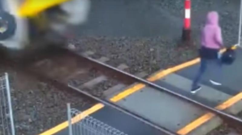 The woman crossed the railway track without looking to her left from where the train came. (Photo: Youtube videograb)