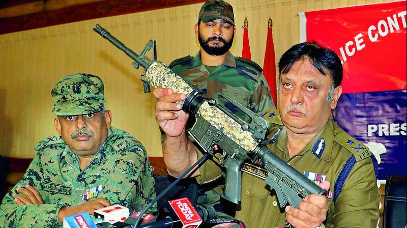 IGP Kashmir Range Muneer Khan shows a US-made M4 carbine rifle, recovered from the militants, during a press conference in Srinagar on Tuesday. (Photo: PTI)