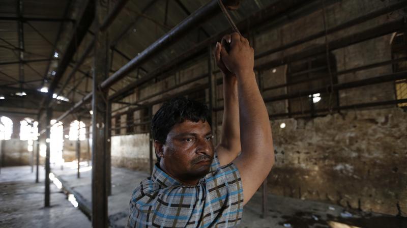 A man stands at a slaughterhouse where he used to work after it was shutdown by authorities in Allahabad. (Photo: AP)