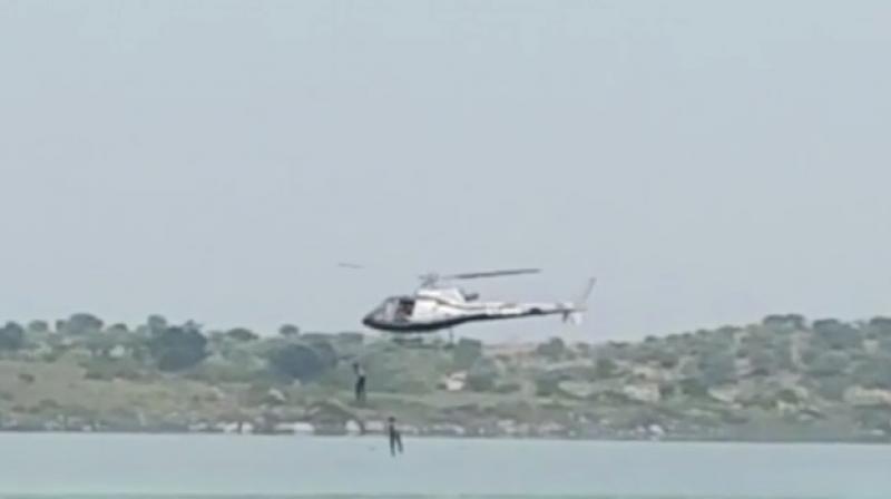Kannada actors jumping from chopper in Thippagondanahalli Reservoir during shoot. (Photo: video grab)