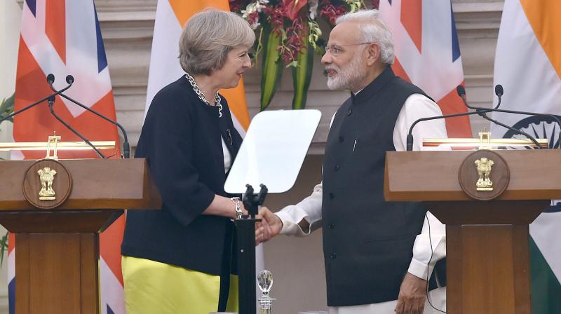 Prime Minister Narendra Modi and UK Prime Minister Theresa May shake hands during the joint statement at Hyderabad House in New Delhi. (Photo: PTI)