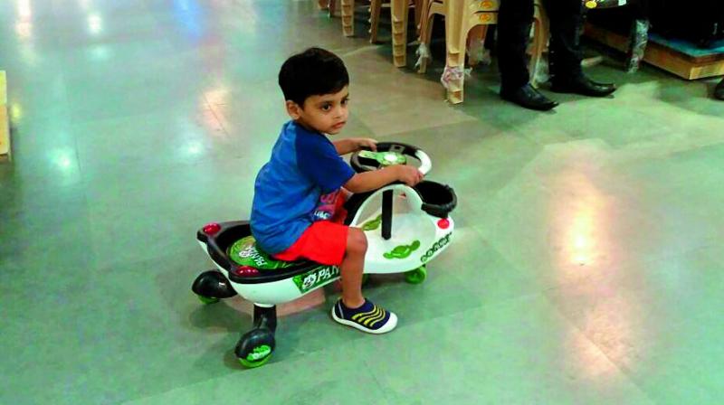 A grab of the three-year-old boy playing on a toy scooter in the toys section of Big Bazaar in Kacheguda.