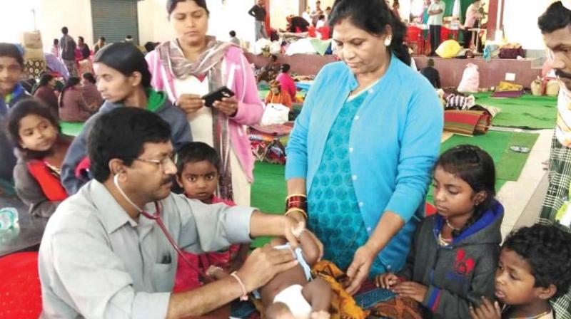 A doctor examines a child at a relief camp in Madikeri on Friday  	 DC