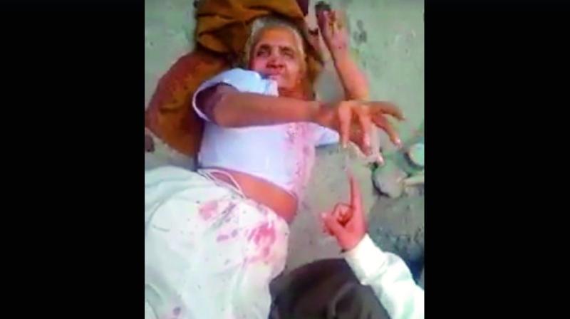 Rajindari Devi lying on the ground after her son had beaten her up