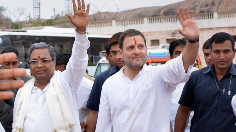 Congress President Rahul Gandhi with Karnataka Chief Minister Siddaramaiah wave to people during a rally in Koppal, Karnataka. (Photo: PTI)