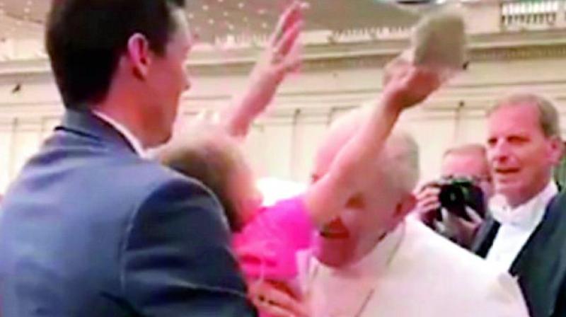 A screengrab from the video posted on Twitter shows three-year-old Estella Westrick  stealing the popes skullcap. (Photo: Via web)