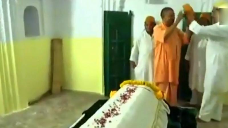 Uttar Pradesh CM Yogi Adityanath refuses to wear karakul, a fur skull cap, when he visited Sant Kabirs Mazar in Magahar on Wednesday. (Photo\ Screengrab | Twitter | ANI)