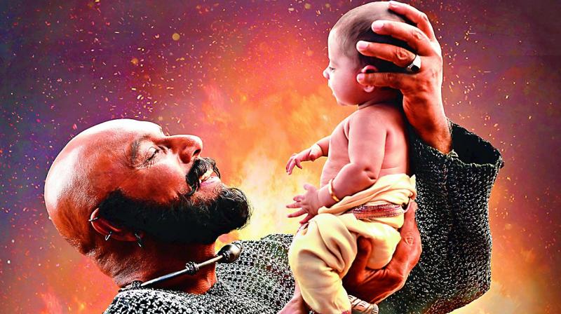 Everyone is curious about why Kattappa killed Baahubali?, so keeping that in mind, the director released a picture of Satyaraj killing Prabhas, and at the same time the same Satyaraj holding a small baby.