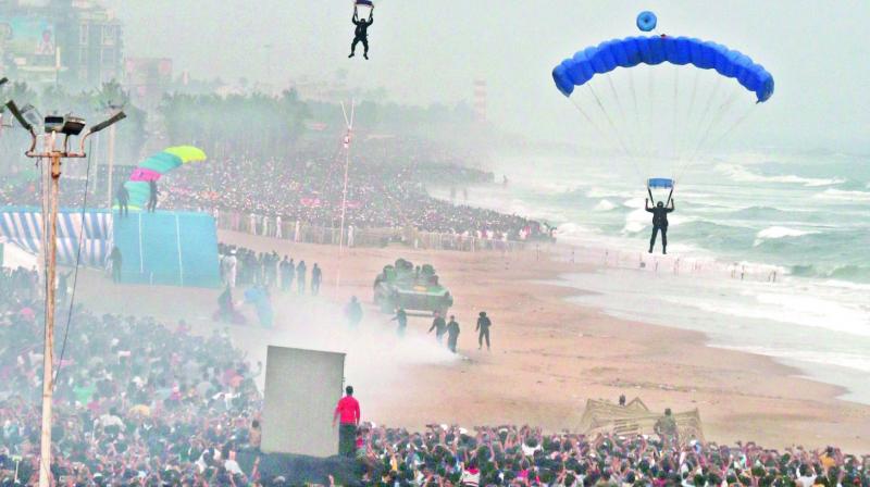 Marine commandos demonstrate on safe landing from parachutes during the Indian Navy Operational Demonstration at the Navy Day celebrations at Ramakrishna Beach in Vizag on Tuesday.