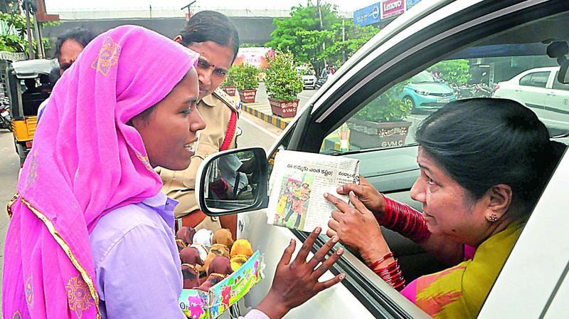 Women Commission chairperson Nannapaneni Rajakumari enquires about a destitute woman with five children in Visakhapatnam on Wednesday. (Photo: DC)