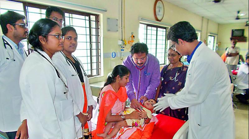 The doctors led by GGH head of neurology department Professor N.V. Sundarachary diagnosing 1-year- old baby Navya. (Photo: DC)