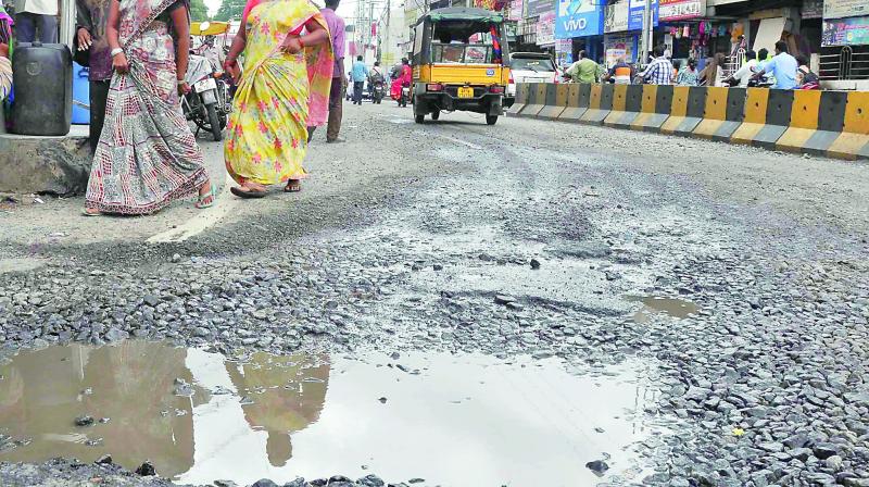 Commuters are having a harrowing experience with the roads damaged in various places due to rains in last three days in Vijayawada. (Photo: DC)