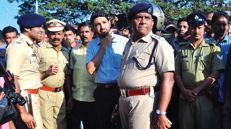 Kannur district collector Mir Mohammed Ali and police chief K.P. Philip in discussion with the officials when the body of slain BJP worker E. Santhosh was brought to Kannur on Thursday (Photo: DC)