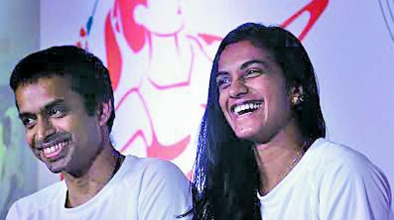 National coach Pullela Gopichand and badminton ace P.V. Sindhu at an event in Mumbai on Wednesday. (Photo: Shripad Naik)