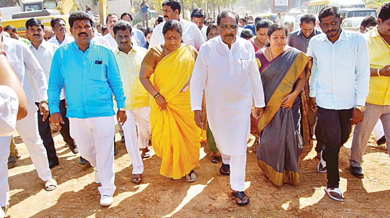 Bengaluru Development Minister K.J. George and BDA officials inspect the construction work of Rani Chennamma flyover on Monday.