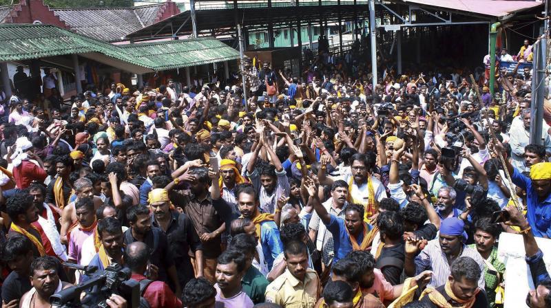 Devotees protest as several female devotee arrive to offer prayers at Sabarimala temple on Sunday. (Photo: PTI)