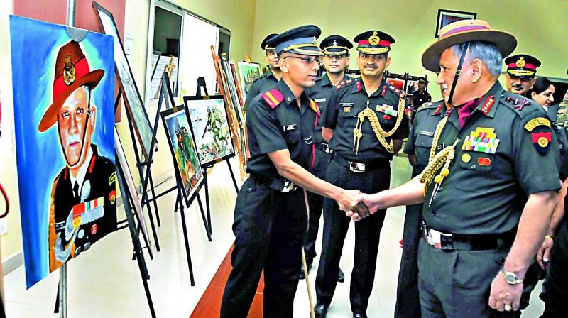 Army Chief Major General Bipin Rawat congratulates cadet Sachin Afaria who painted the Generals portrait during 64th convocation ceremony of MCEME held in Secunderabad Military Station on Friday.  (Photo: P. Surendra)