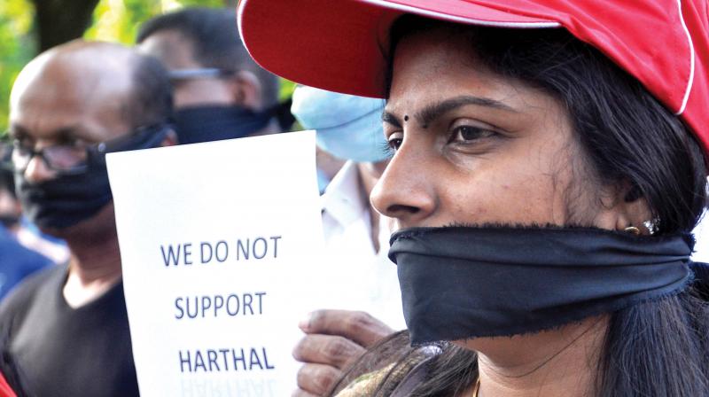 Participants covering their mouths with black cloth take part in a protest march organised by various tourism organisations against the hartals, in Kochi on Friday. (Photo: SUNOJ NINAN MATHEW)