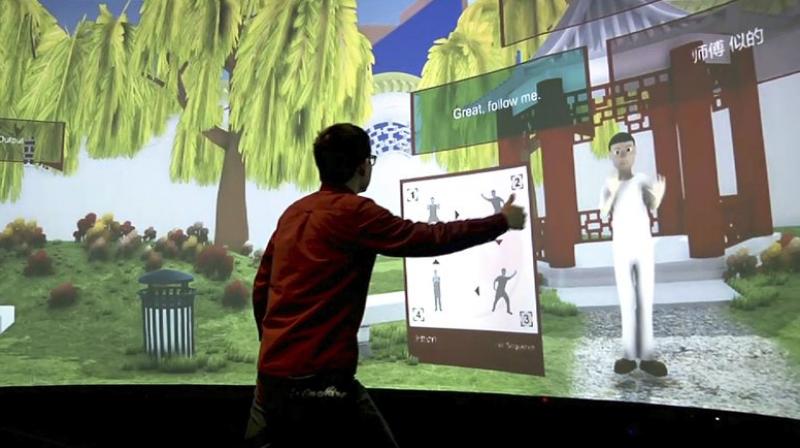 Rensselaer Polytechnic Institute graduate student Xiangyang Mou practices tai chi with an avatar in a campus studio at Rensselaer Polytechnic Institute in Troy, NY. The  Mandarin Project  is a joint venture of RPI and IBM. (AP Photo/Michael Hill)