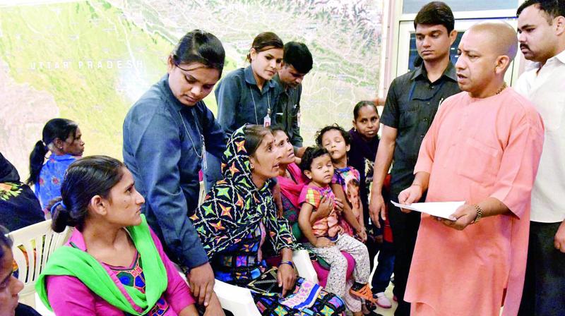 Uttar Pradesh Chief Minister Yogi Adityanath listening to problems of people during his Janata Darbar in Lucknow on Wednesday. (Photo: PTI)