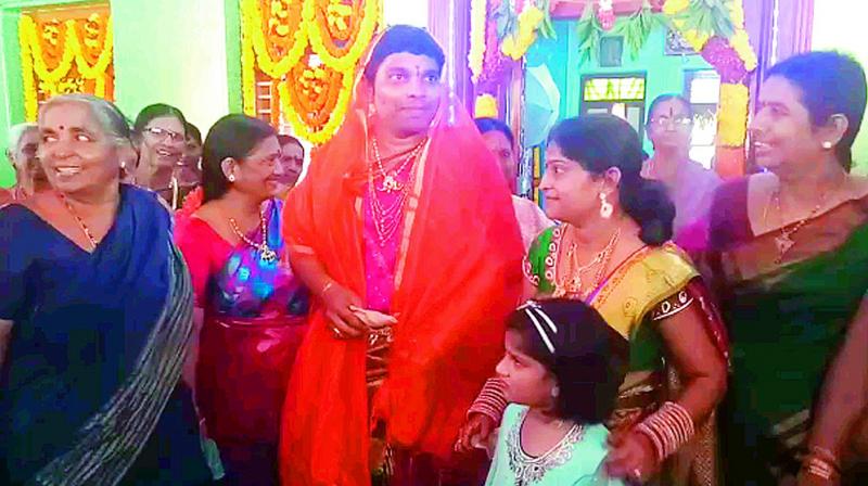 Groom Gannamani Raviteja dressed as bride takes part in a procession on a cart being pulled by two horses as family tradition at Jagannadhapuram village of Tadepalligudem mandal in West Godavari on Wednesday. (Photo: DC)