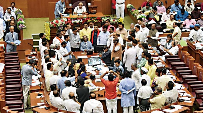 BJP MLAs stage a protest in the well of the House during winter session in Belagavi on Friday 	 DC