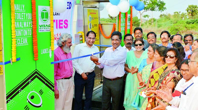 Director (Operations) of RINL-VSP D.N. Rao inaugurates the e-toilets facility in the presence of the president of VMS Bindoo Mohapatra and others in Visakhapatnam on Friday. (Photo: DC)