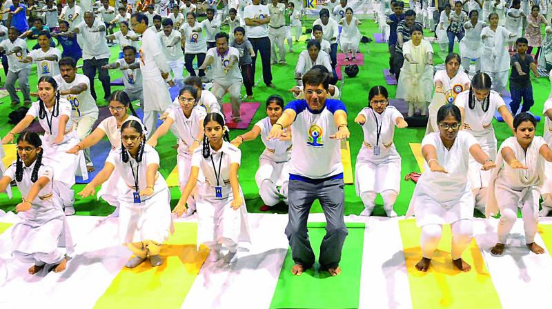 Union power minister Piyush Goyal participates in a yoga session to celebrate the 3rd International Yoga Day at the SwarnaBharathi Indoor Stadium in Visakhapatnam on Wednesday. (Photo: DC)