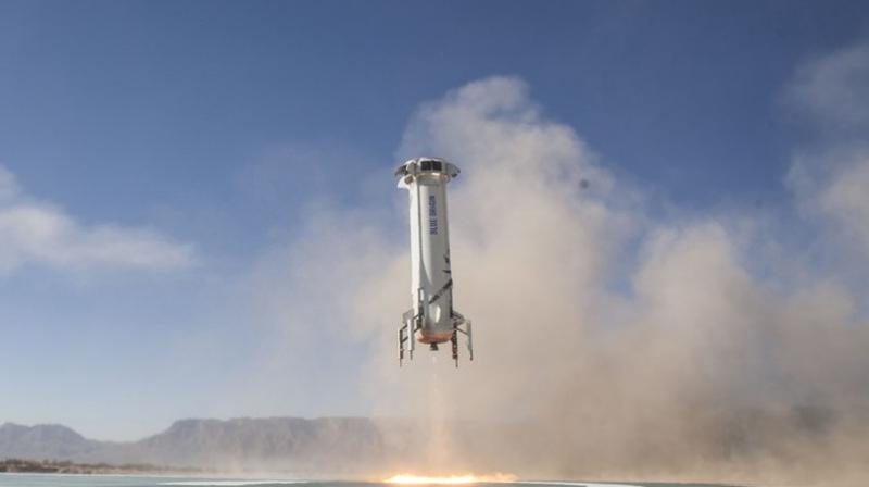 In this file photo provided by Blue Origin, the New Shepard booster lands in west Texas during a test. (Blue Origin via AP)