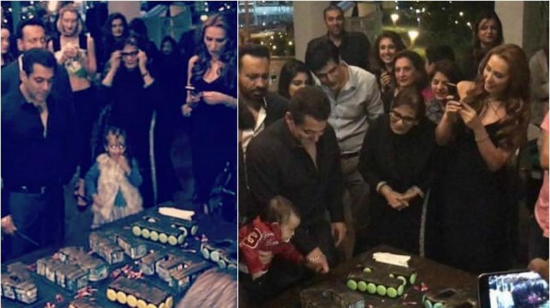Salmans rumoured girlfriend Iulia stands by his side as he cuts his birthday cake