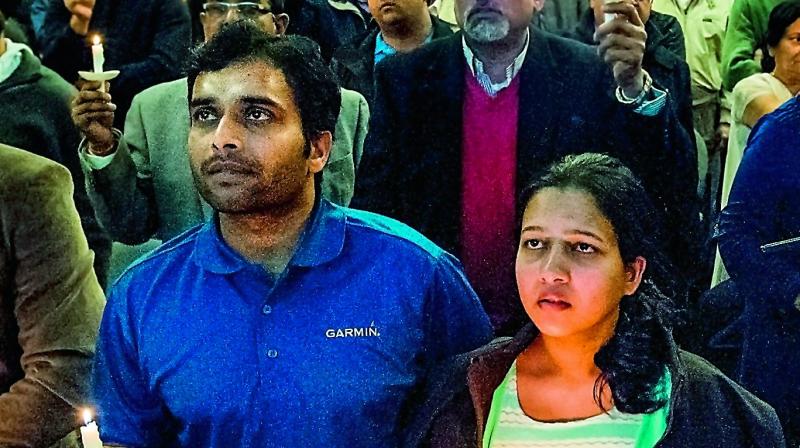 Alok Madasani, left, and his wife Reepthi Gangula hold candles during the prayer vigil held at the Ball Conference Centre in Olathe, Kansas on Sunday. (Photo: PTI)