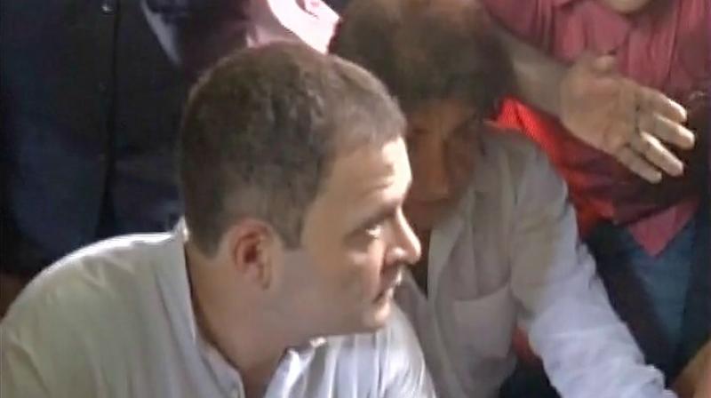 Congress vice president Rahul Gandhi speaks with villagers at UP border area. (Photo: Twitter | ANI)