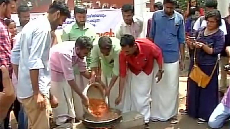 SFI protests on cattle slaughter ban by eating beef outside University College in Thiruvananthapuram. (Photo: Twitter | ANI)