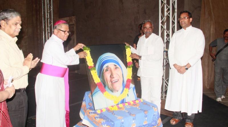 Archbishop Rt. Rev. Thumma Bala garlands a potrait of Saint Mother Teresa on her 20th death anniversary in Hyderabad on Friday.  (Photo: DC)