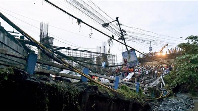 A section of Majerhat bridge collapsed in Kolkata on Tuesday. According to the police, a portion of the bridge collapsed this evening, claiming one life, trapping several people and crushing many vehicles. (Photo: PTI)