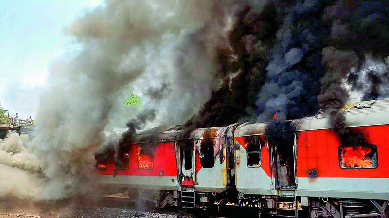 Smoke billows out of the two bogies of Andhra Pradesh AC Superfast Express which caught fire near a station in Gwalior on Monday morning. (Photo:PTI)