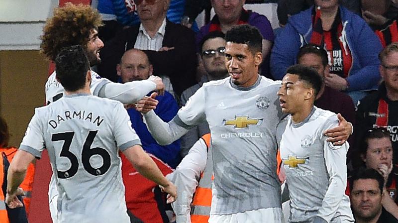 Smalling (2nd from right) netted his third goal in six league games by meeting a low cross from Jesse Lingard and slotting into an empty net in the 28th minute. (Photo: AFP)