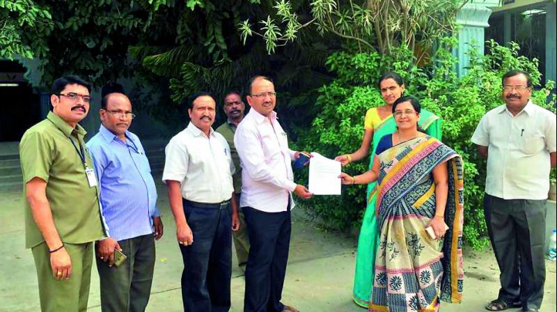 GHMC officials accept the approval letter from the management of St Josephs School, Habsiguda, allowing citizens to use the school playground, provided they carry a photo ID card.