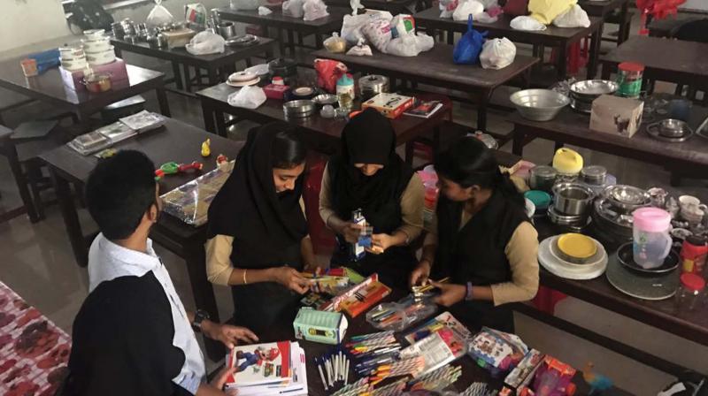 Students of Asmabi college engaged in packing materials for anganwadi students.