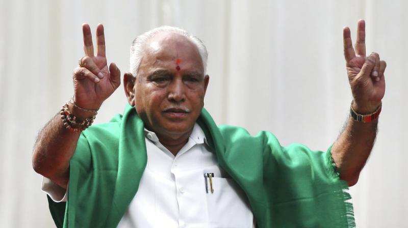 B S Yeddyurappa flashes victory sign after he was sworn in as Chief Minister of Karnataka. (Photo: AP)