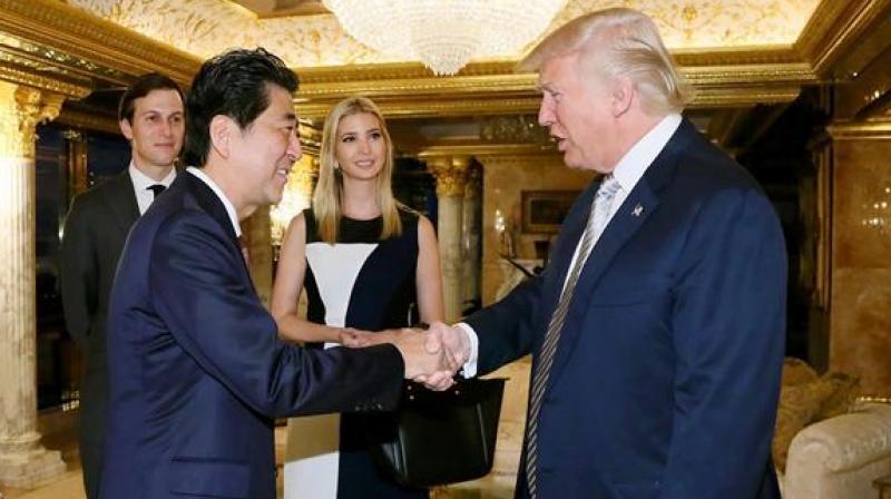 Japanese Prime Minister Shinzo Abe being welcomed by US President-elect Donald Trump, beside Ivanka Trump (C) and her husband Jared Kushner (L) in New York. (Photo: AFP)