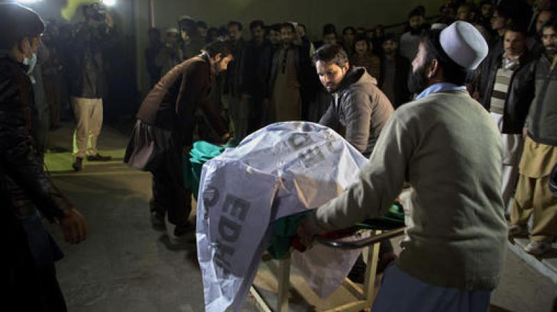 Pakistani volunteers move remains of plane crash victims to a mortuary at a hospital, in Abbottabad, Pakistan. (Photo: AP)