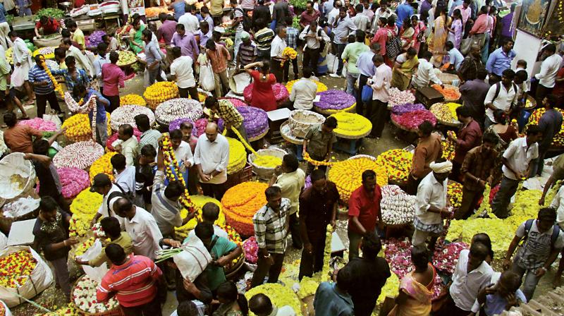People purchase flowers and other pooja materials for Ugadi at Malleswaram. (Photo: DC)