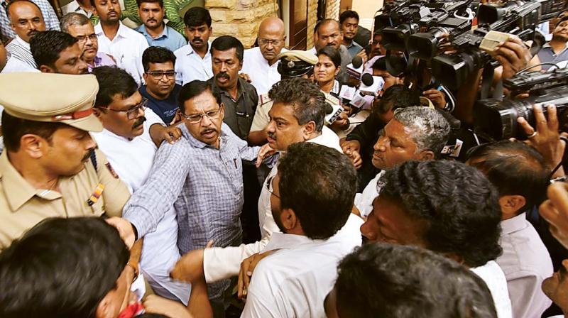Deputy Chief Minister Dr G. Parameshwar being heckled by supporters of senior Congress leader M.B. Patil, in Bengaluru on Friday.  (Photo:DC)