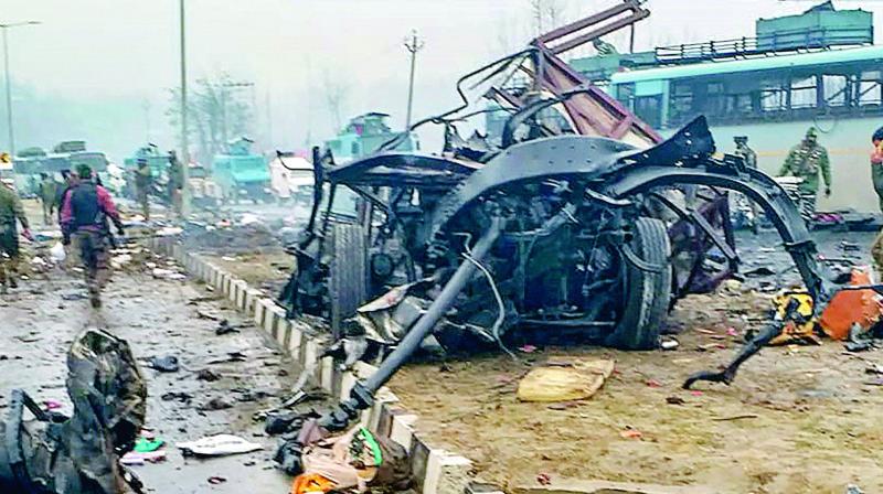 The mangled remains of the bus the CRPF jawans were travelling in when their convoy was attacked in Goripora area of Awantipora town in Pulwama district on Thursday.  (PTI)